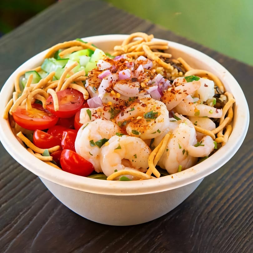 Sprout Mediterranean salad with shrimp, cherry tomatoes, cucumbers, red onions, and crispy noodles.